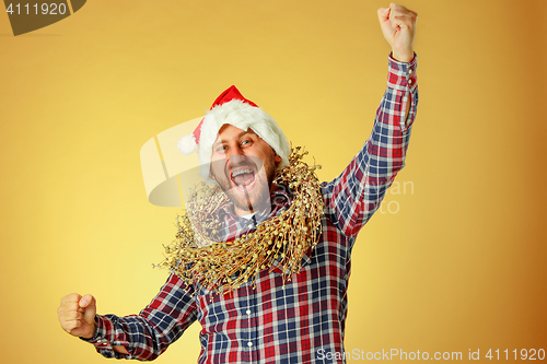 Image of Smiling christmas man wearing a santa hat