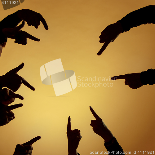 Image of Many hands pointing ahead or out on orange background