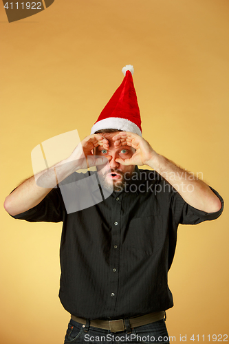 Image of The Surprised christmas man wearing a santa hat