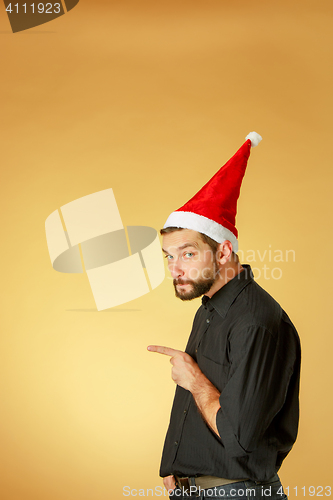 Image of The serious christmas man wearing a santa hat