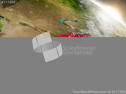 Image of Kyrgyzstan with flag in rising sun