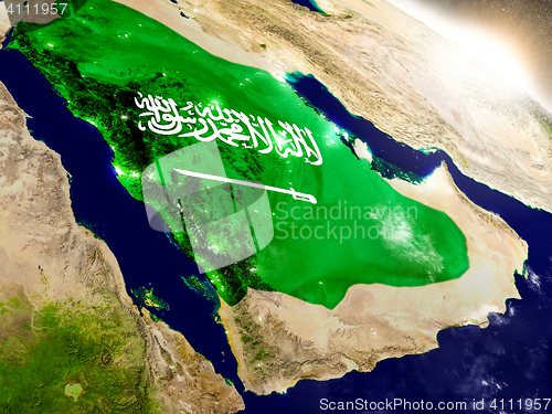 Image of Saudi Arabia with flag in rising sun