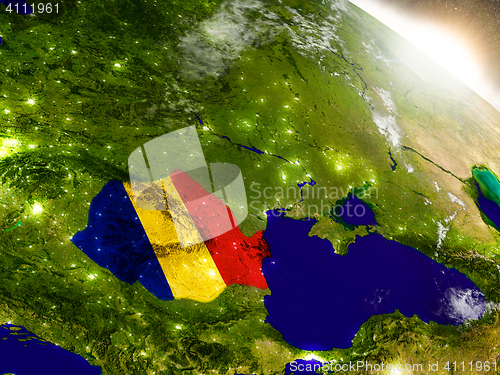 Image of Romania with flag in rising sun