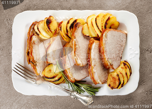 Image of roasted pork slices on white plate