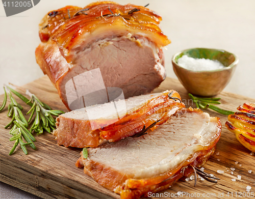 Image of roasted pork on wooden cutting board