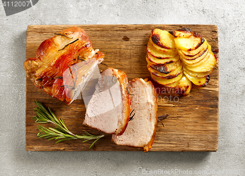 Image of roasted pork on wooden cutting board