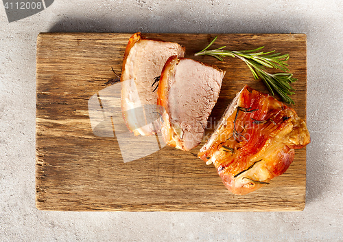 Image of roasted pork on wooden cutting board