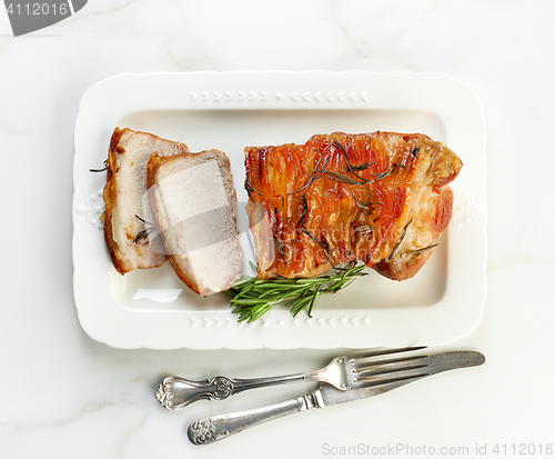 Image of sliced roasted pork on white plate