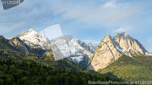 Image of Springtime morning snowy Alps mountains panoramic scenic view