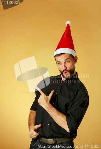 Image of Smiling christmas man wearing a santa hat