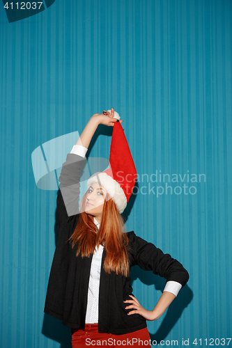 Image of The christmas girl wearing a santa hat