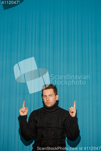 Image of Portrait of young man with serious facial expression
