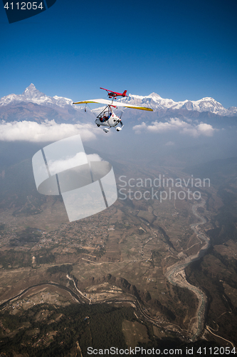 Image of Ultralight trike and plane fly over Pokhara and Annapurna region