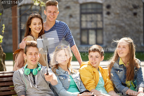 Image of happy teenage students taking selfie by smartphone