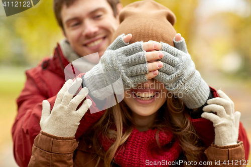 Image of happy young couple having fun in autumn park