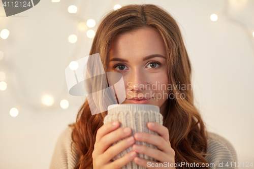Image of happy woman with cup of tea or coffee at home