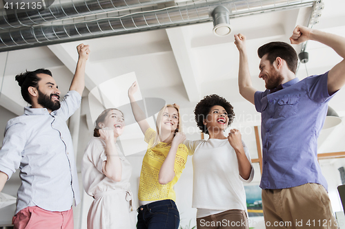 Image of happy creative team in office