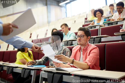 Image of teacher giving tests to students at lecture