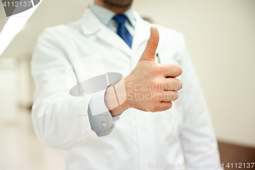 Image of close up of doctor at hospital showing thumbs