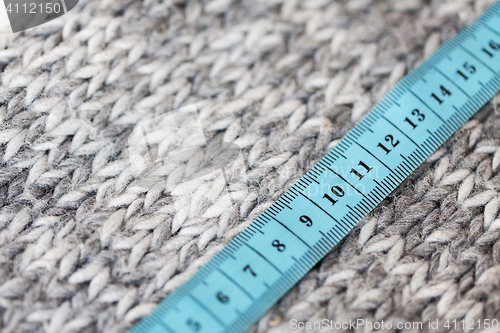 Image of close up of knitted item with measuring tape