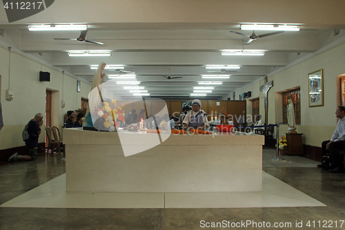 Image of Pilgrims pray beside the tomb of Mother Teresa in Kolkata, West Bengal, India 