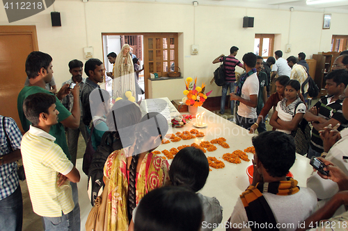 Image of Pilgrims pray beside the tomb of Mother Teresa in Kolkata, West Bengal, India 