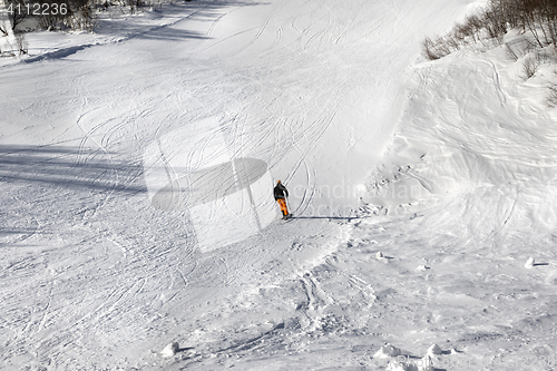 Image of Skier on ski slope at sun winter day