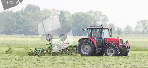 Image of Leeuwarden, the Netherlands - May 26, 2016: Farmer uses tractor 