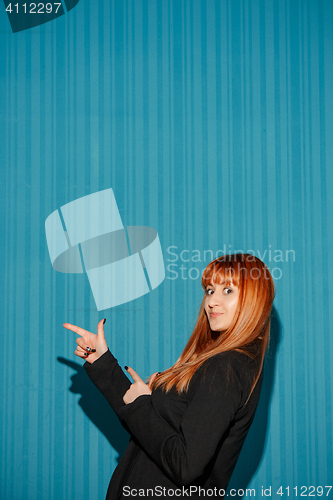 Image of Portrait of young woman with shocked facial expression