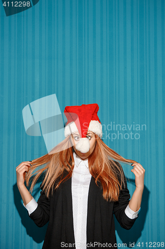 Image of The christmas girl wearing a santa hat