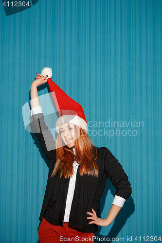 Image of The christmas girl wearing a santa hat