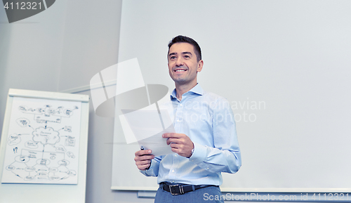 Image of smiling businessman on presentation in office