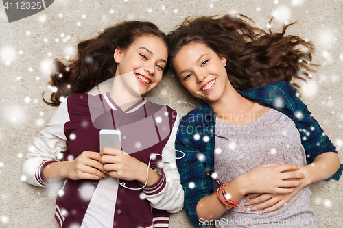 Image of teenage girls listening to music on smartphone