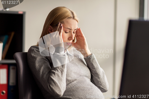 Image of pregnant businesswoman feeling sick at office work