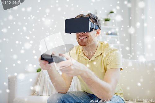 Image of man in virtual reality headset with controller