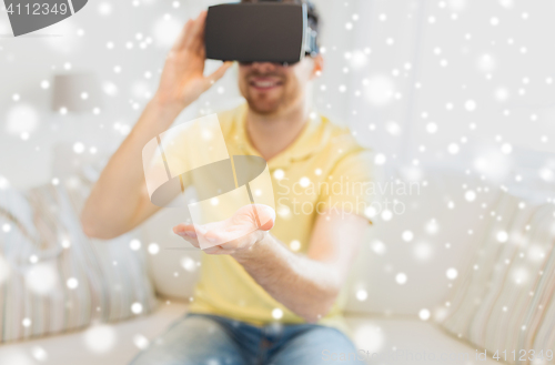 Image of young man in virtual reality headset or 3d glasses