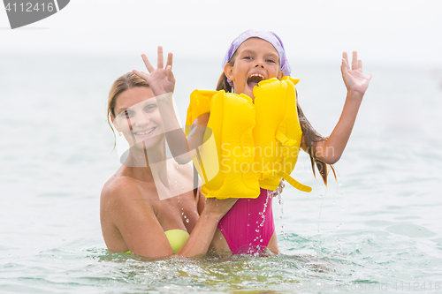 Image of She pulled out of the water his seven-year daughter in the swimming vest