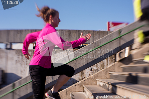 Image of woman  stretching before morning jogging