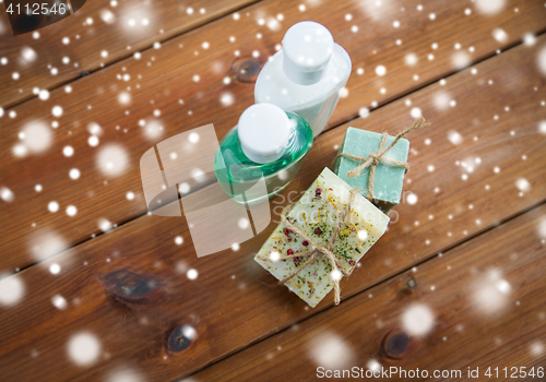 Image of handmade soap bars and lotions on wood