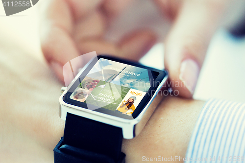 Image of close up of hands with application on smartwatch