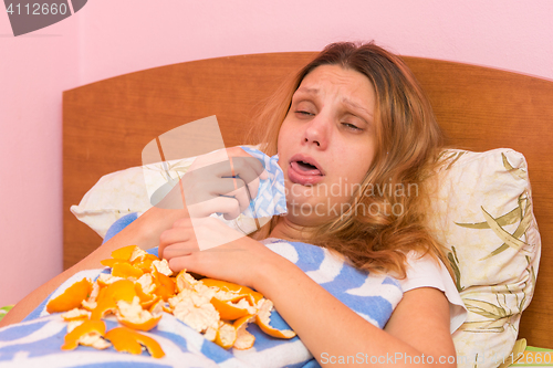 Image of Young girl coughing heavily lying in bed