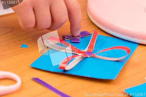 Image of The child sticks to the bow Crafts for mom, close up