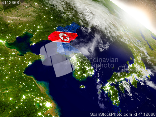 Image of North Korea with flag in rising sun