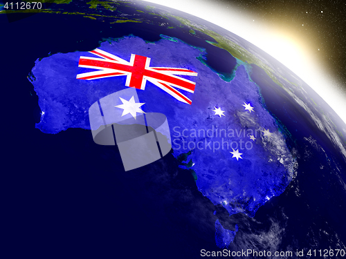 Image of Australia with flag in rising sun