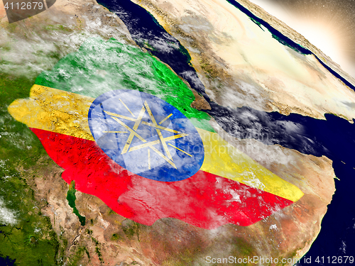 Image of Ethiopia with flag in rising sun