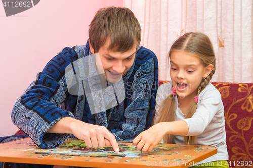 Image of Dad and daughter are happy that you have found a place for the next mosaic element