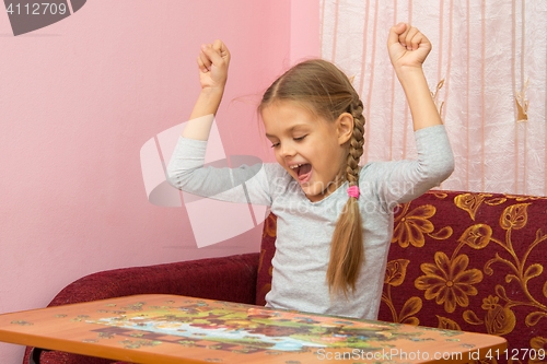 Image of Girl is happy to have found the item you want the puzzle