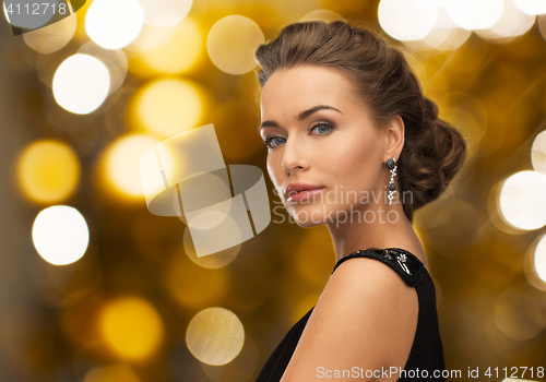 Image of woman in evening dress and earring