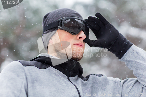 Image of close up of sports man with ski goggles in winter