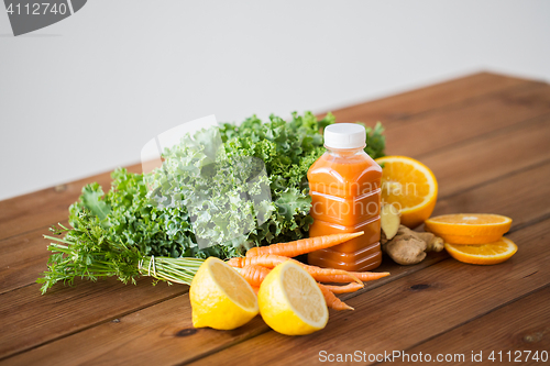 Image of bottle with carrot juice, fruits and vegetables